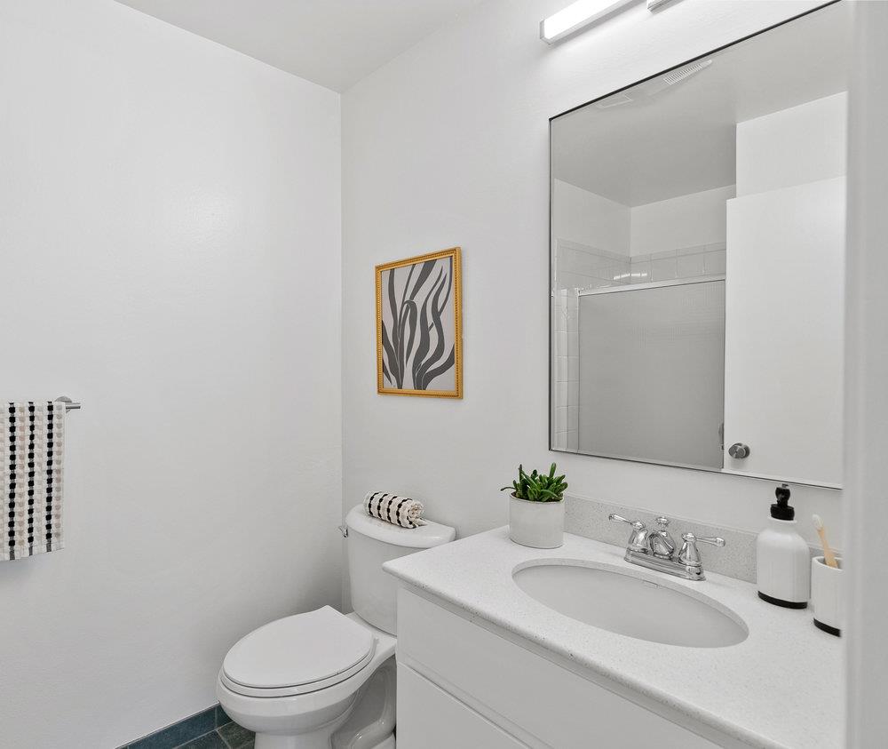 1020 Shoreline Drive San Mateo, CA 94404 - Photo 23 of 46 a bathroom with a toilet a sink and mirror