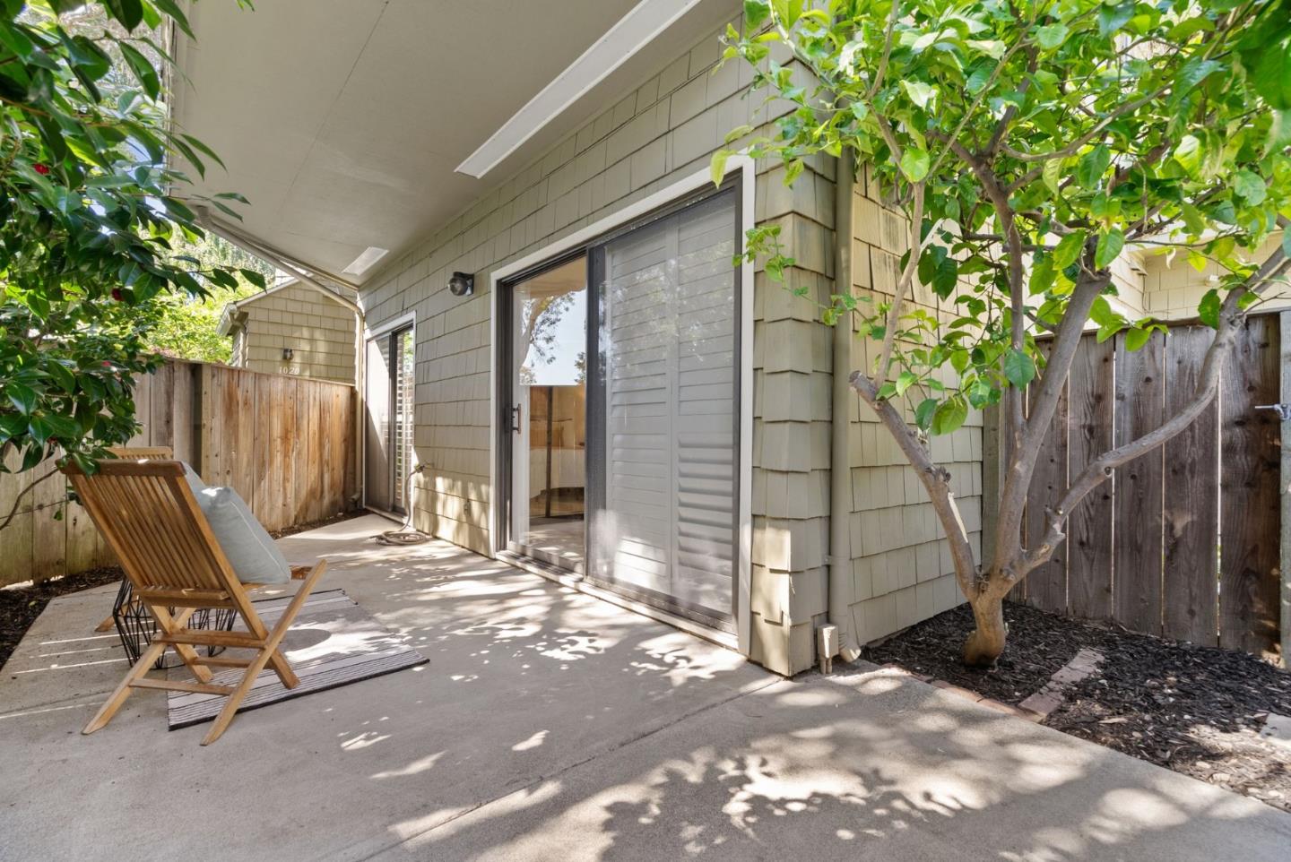 1020 Shoreline Drive San Mateo, CA 94404 - Photo 29 of 46 a view of backyard with wooden fence and a large tree