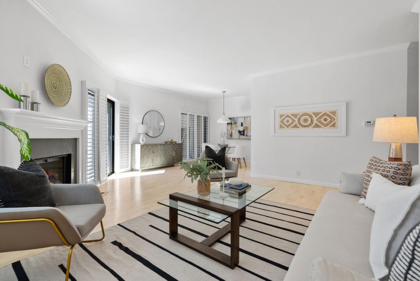 1020 Shoreline Drive San Mateo, CA 94404 - Photo 9 of 46 a living room with furniture a table and wall paintings