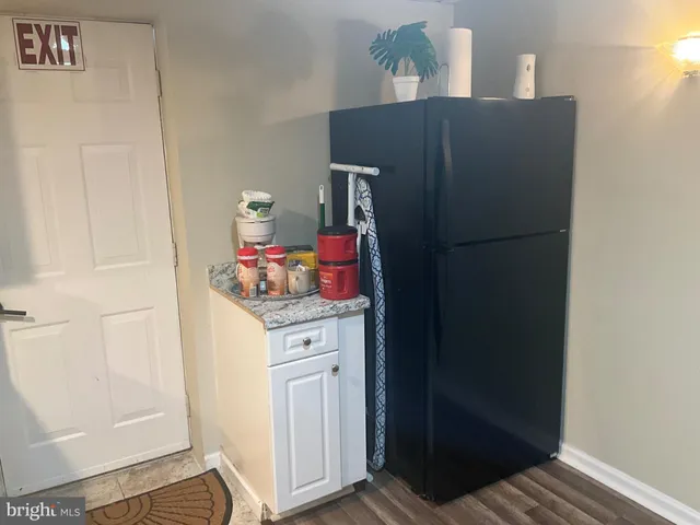 a kitchen with a refrigerator and cabinets