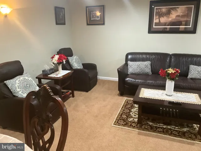 a living room with furniture and flowers