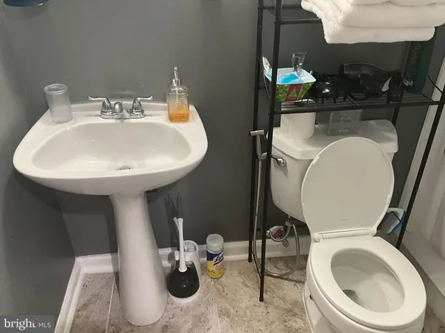 a bathroom with a sink mirror and toilet