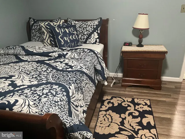 a bedroom with a bed and a lamp