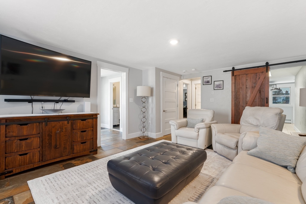 9 Riverside Road Billerica, MA 01821 - Photo 11 of 42 a living room with furniture and a flat screen tv