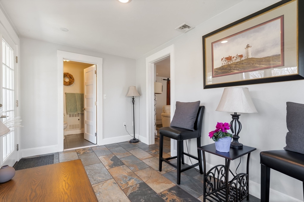 9 Riverside Road Billerica, MA 01821 - Photo 14 of 42 a living room with furniture and a potted plant