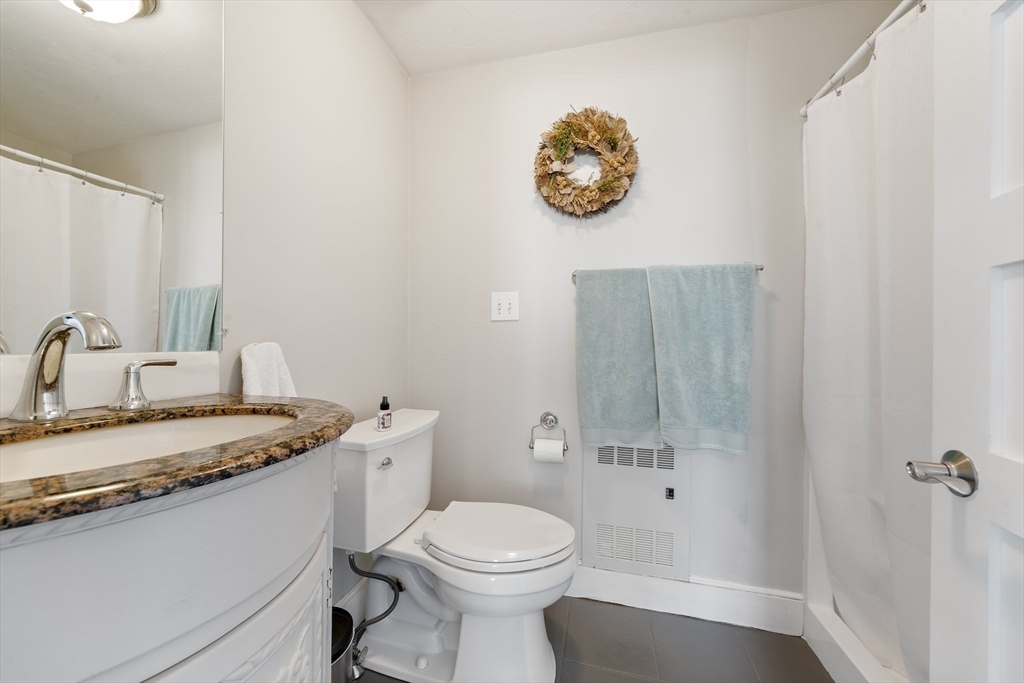 9 Riverside Road Billerica, MA 01821 - Photo 15 of 42 a bathroom with a sink a toilet and shower