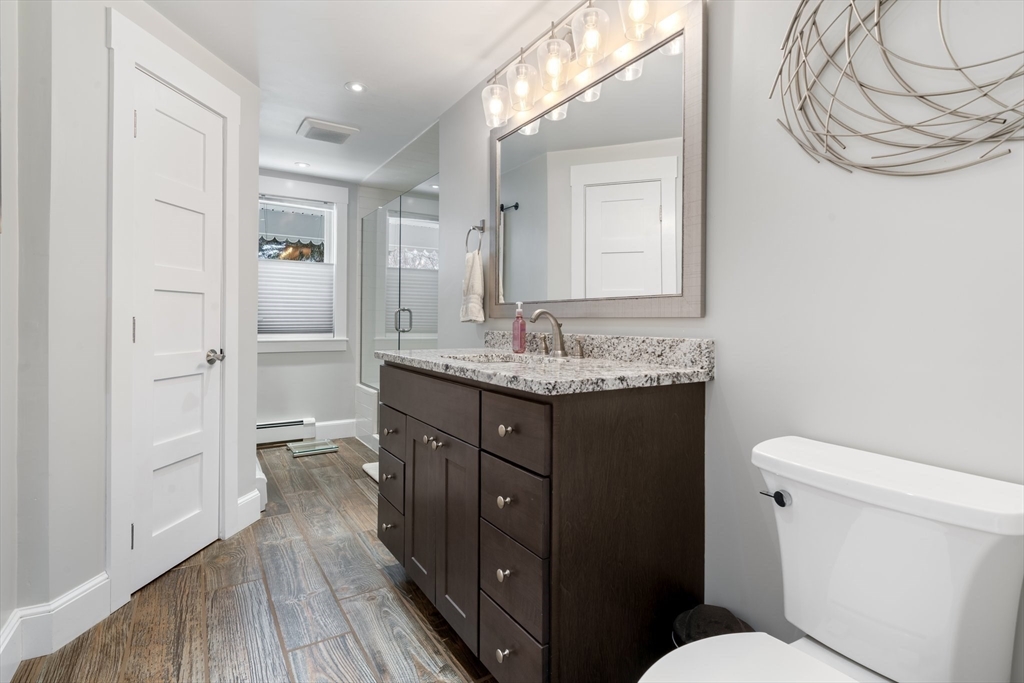 9 Riverside Road Billerica, MA 01821 - Photo 16 of 42 a bathroom with a granite countertop sink toilet and shower