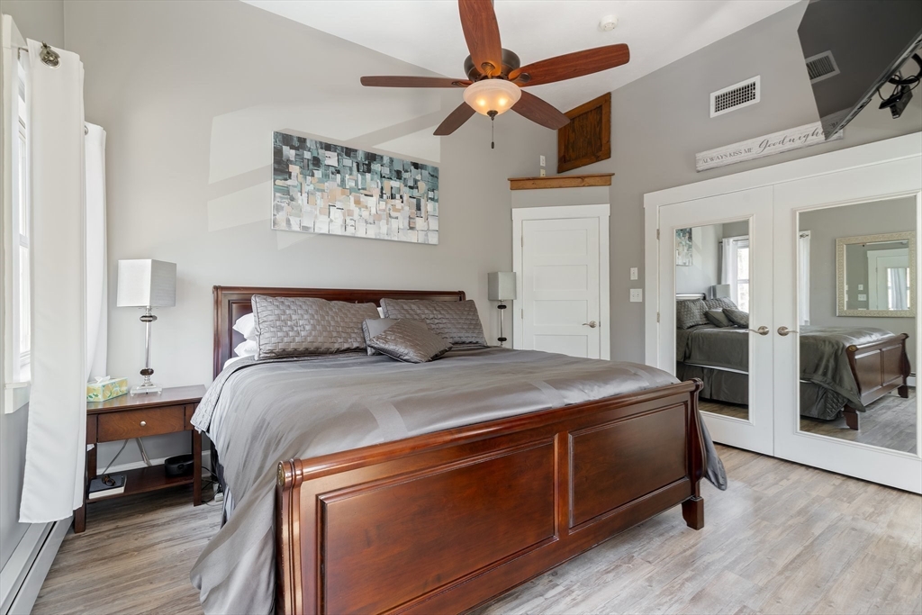 9 Riverside Road Billerica, MA 01821 - Photo 27 of 42 a bedroom with a bed and a chandelier