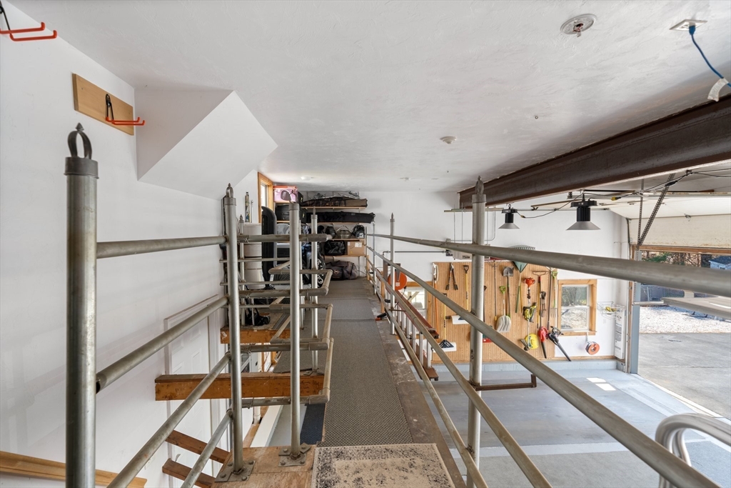 9 Riverside Road Billerica, MA 01821 - Photo 33 of 42 a view of a hallway with wooden floor and staircase