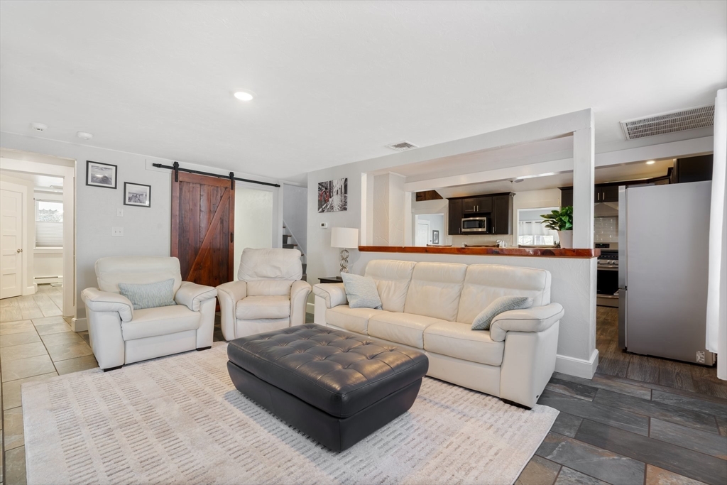 9 Riverside Road Billerica, MA 01821 - Photo 10 of 42 a living room with furniture and a wooden floor