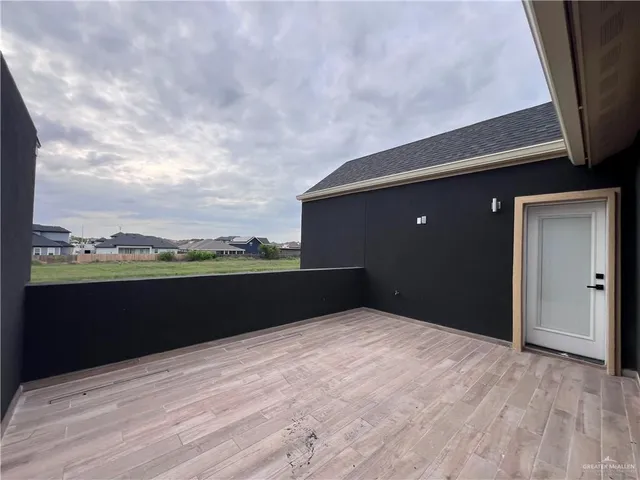 a view of hallway with a window and wooden floor