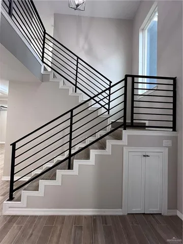 a bathroom with a toilet sink vanity and mirror