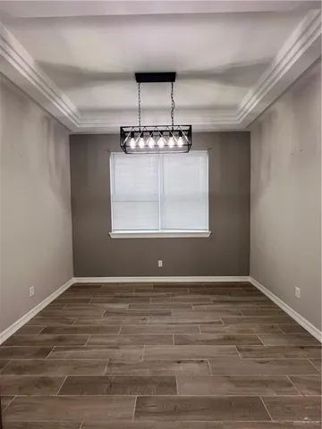 a kitchen with refrigerator a sink and wooden floor