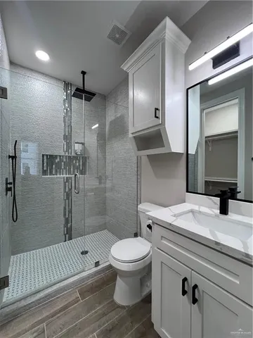 a bathroom with a sink toilet and shower