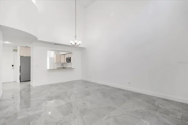 a view of a big room with wooden cabinet and a kitchen