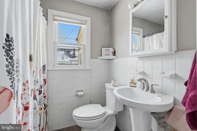 a bathroom with a sink mirror and toilet