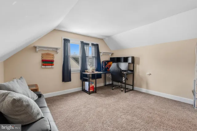 a view of a livingroom with workspace and a couch