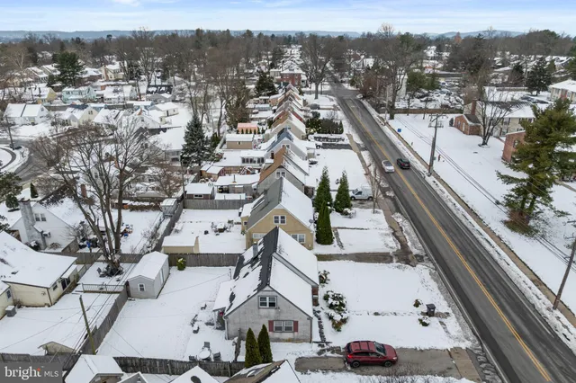an aerial view of residential houses with city view