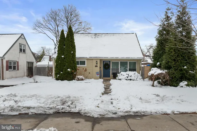 a view of a house with a snow in the yard