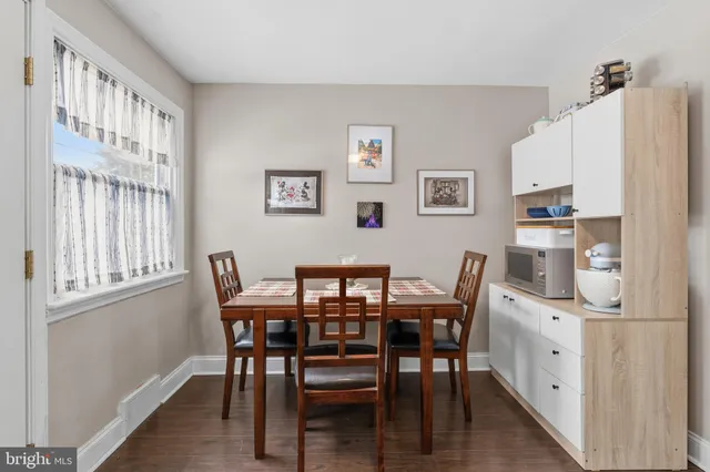 a view of a dining room with furniture and window