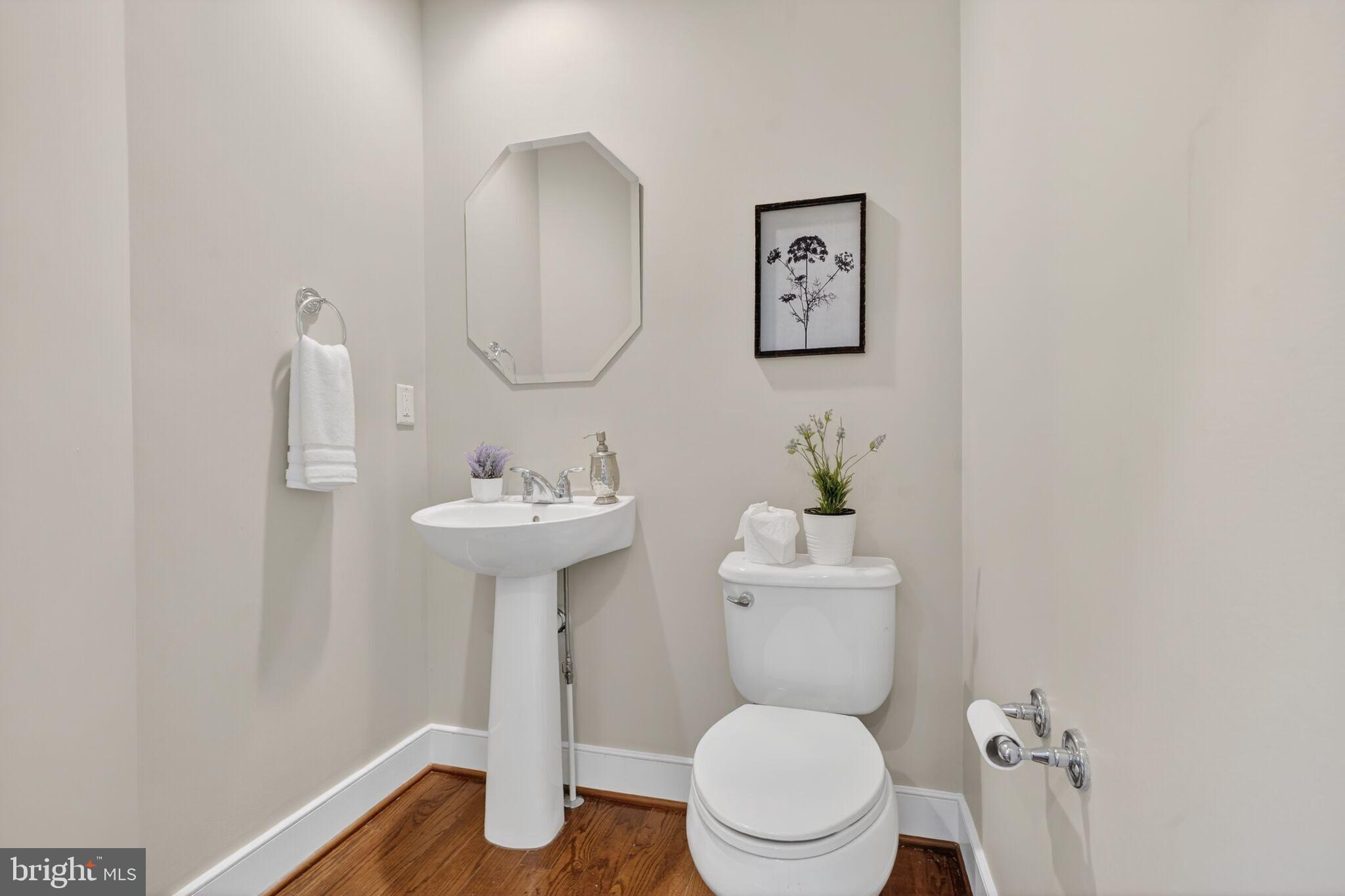 2909 Chancellor's Way Northeast Washington, DC 20017 - Photo 13 of 31 a bathroom with a toilet a sink and a mirror