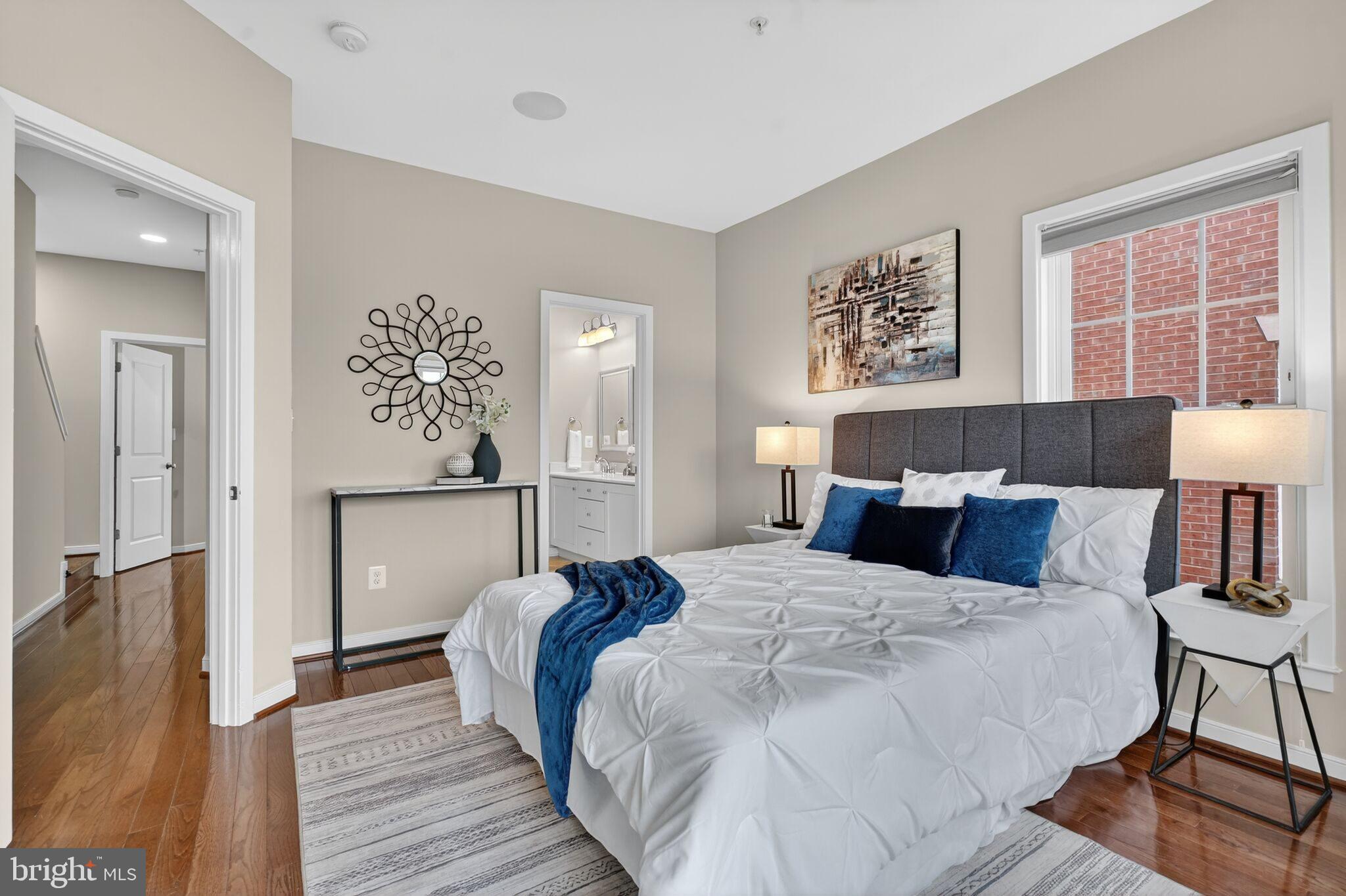 2909 Chancellor's Way Northeast Washington, DC 20017 - Photo 15 of 31 a bed room with a bed a lamp and a large window