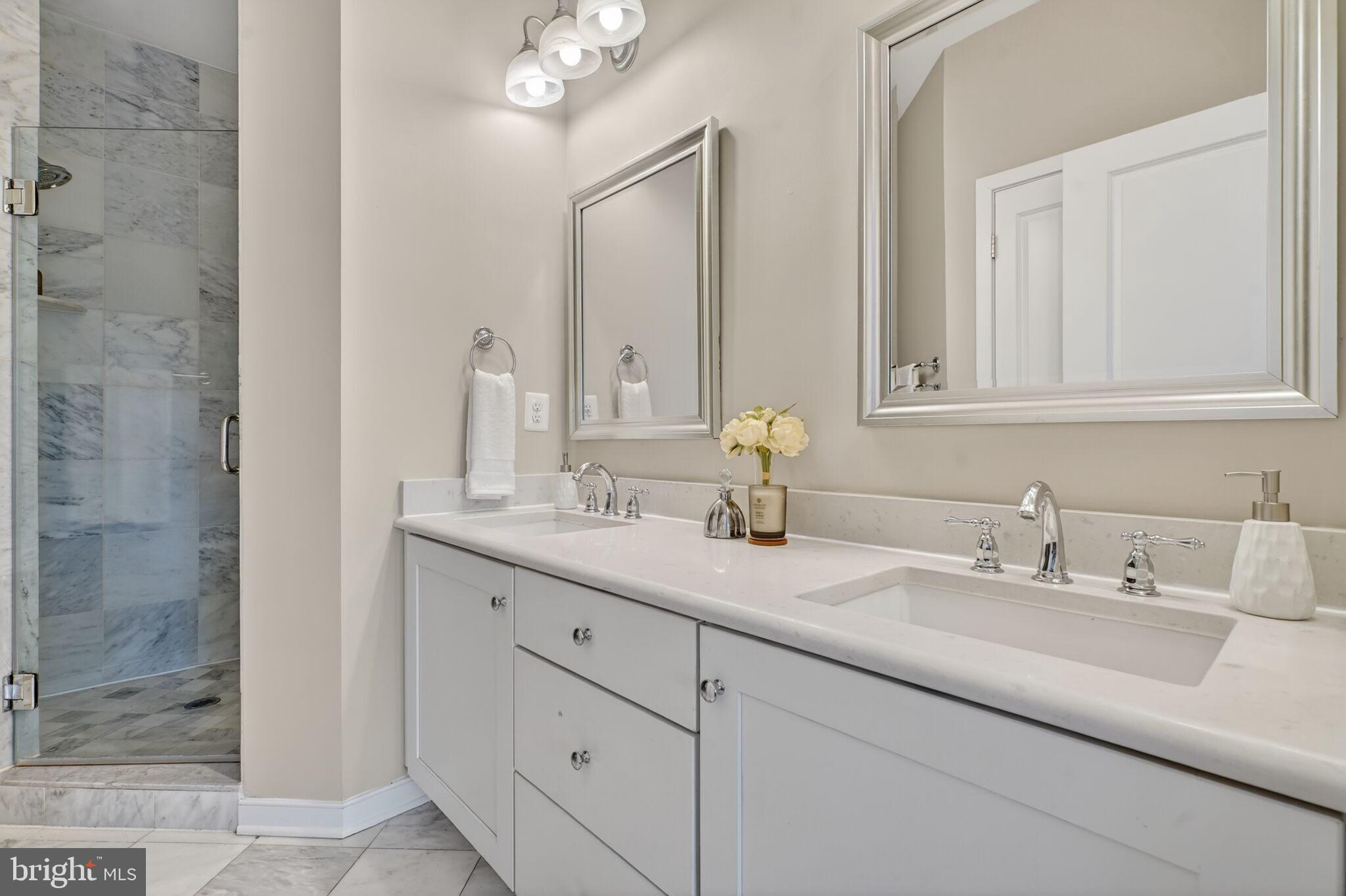 2909 Chancellor's Way Northeast Washington, DC 20017 - Photo 16 of 31 a bathroom with double sink and a mirror
