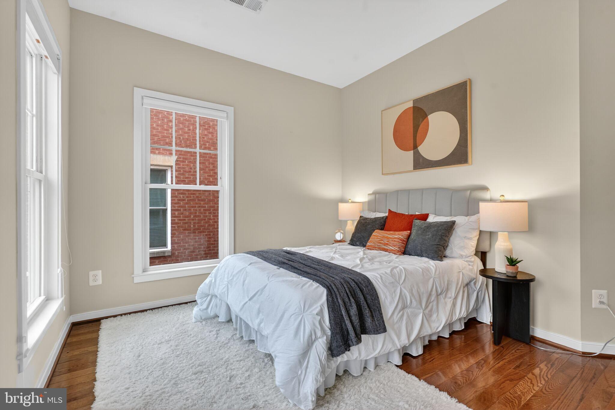 2909 Chancellor's Way Northeast Washington, DC 20017 - Photo 18 of 31 a bedroom with a bed and wooden floor