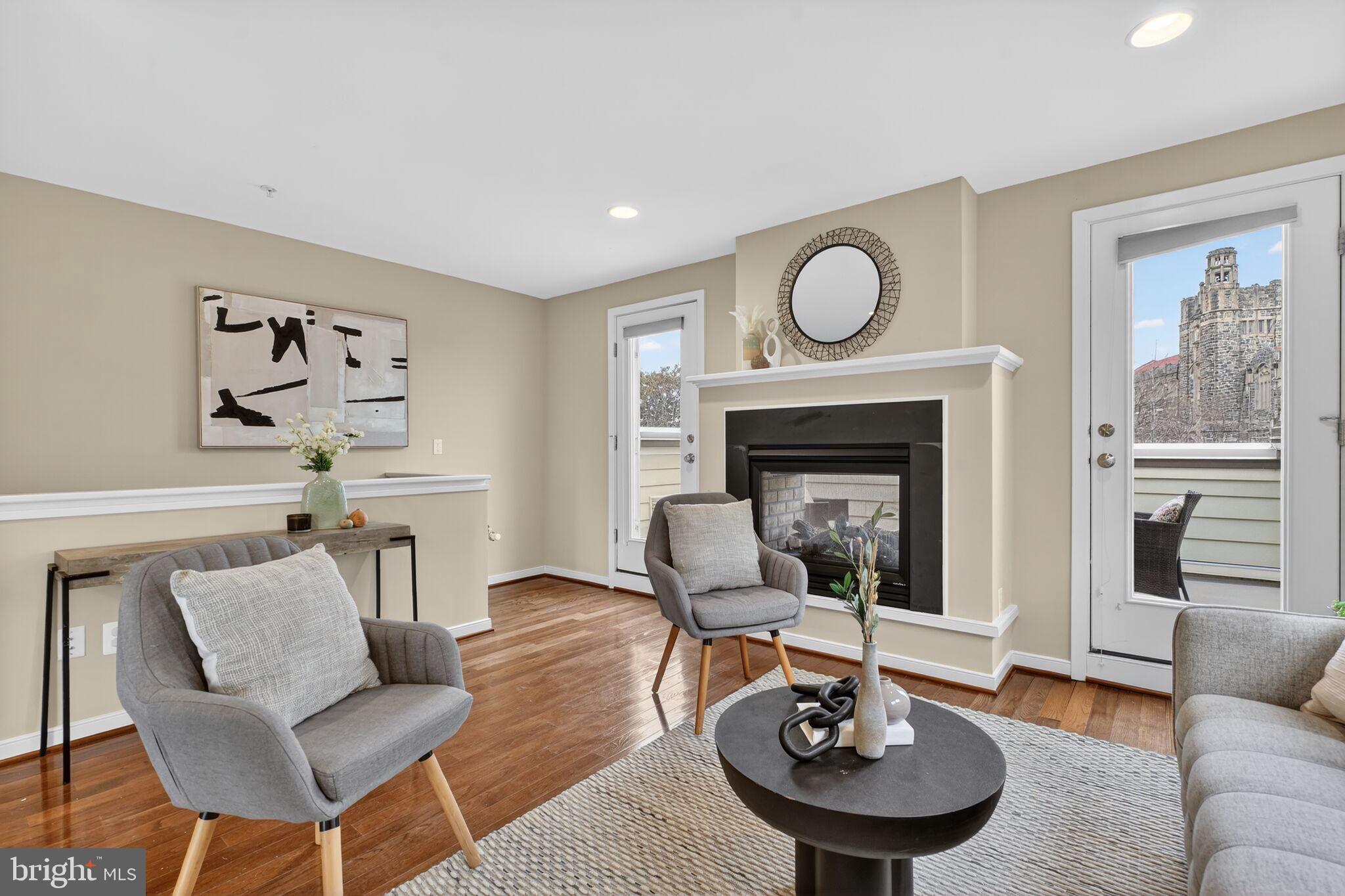 2909 Chancellor's Way Northeast Washington, DC 20017 - Photo 21 of 31 a living room with furniture a fireplace and kitchen view