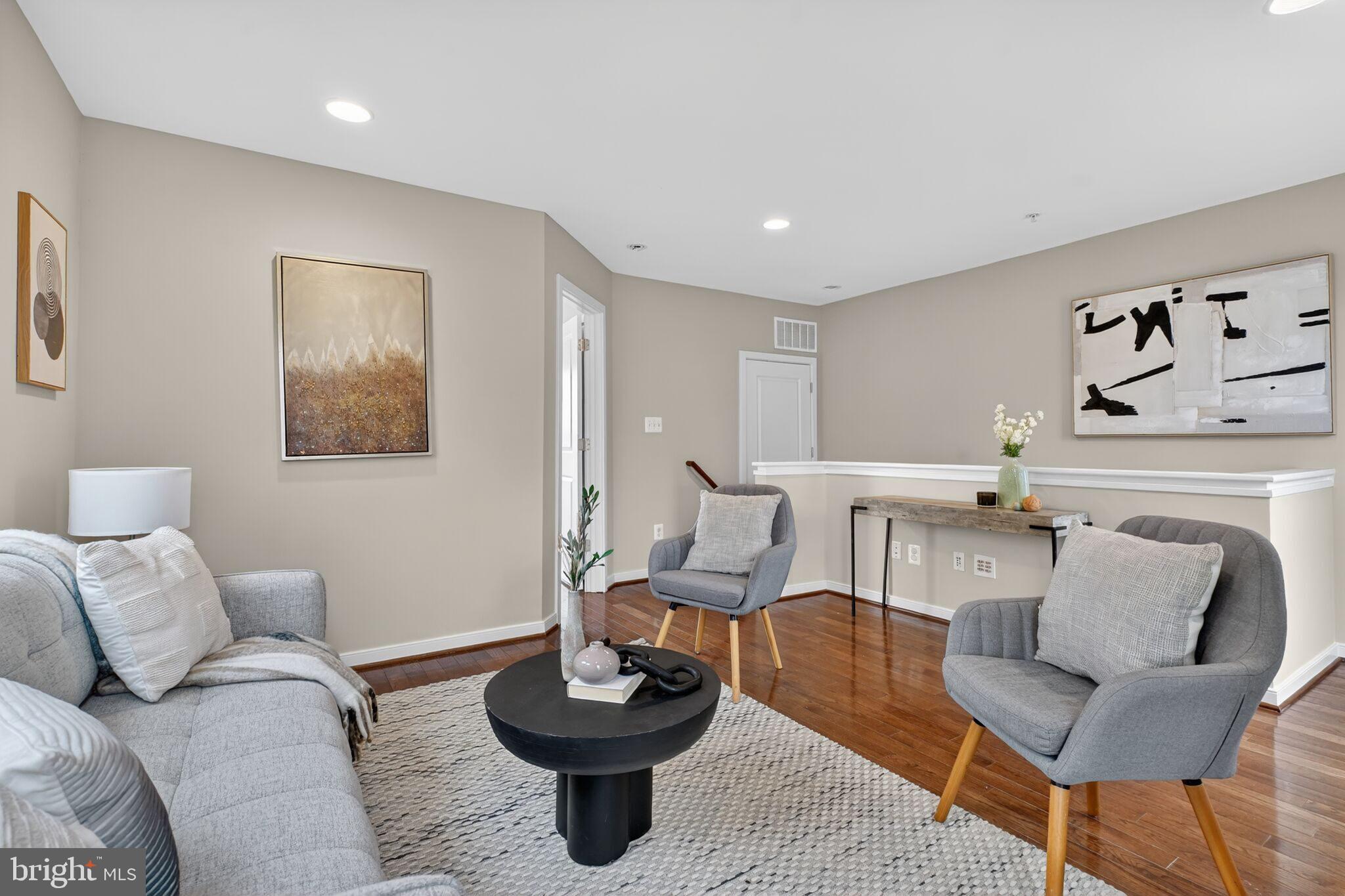 2909 Chancellor's Way Northeast Washington, DC 20017 - Photo 22 of 31 a living room with furniture and a wooden floor