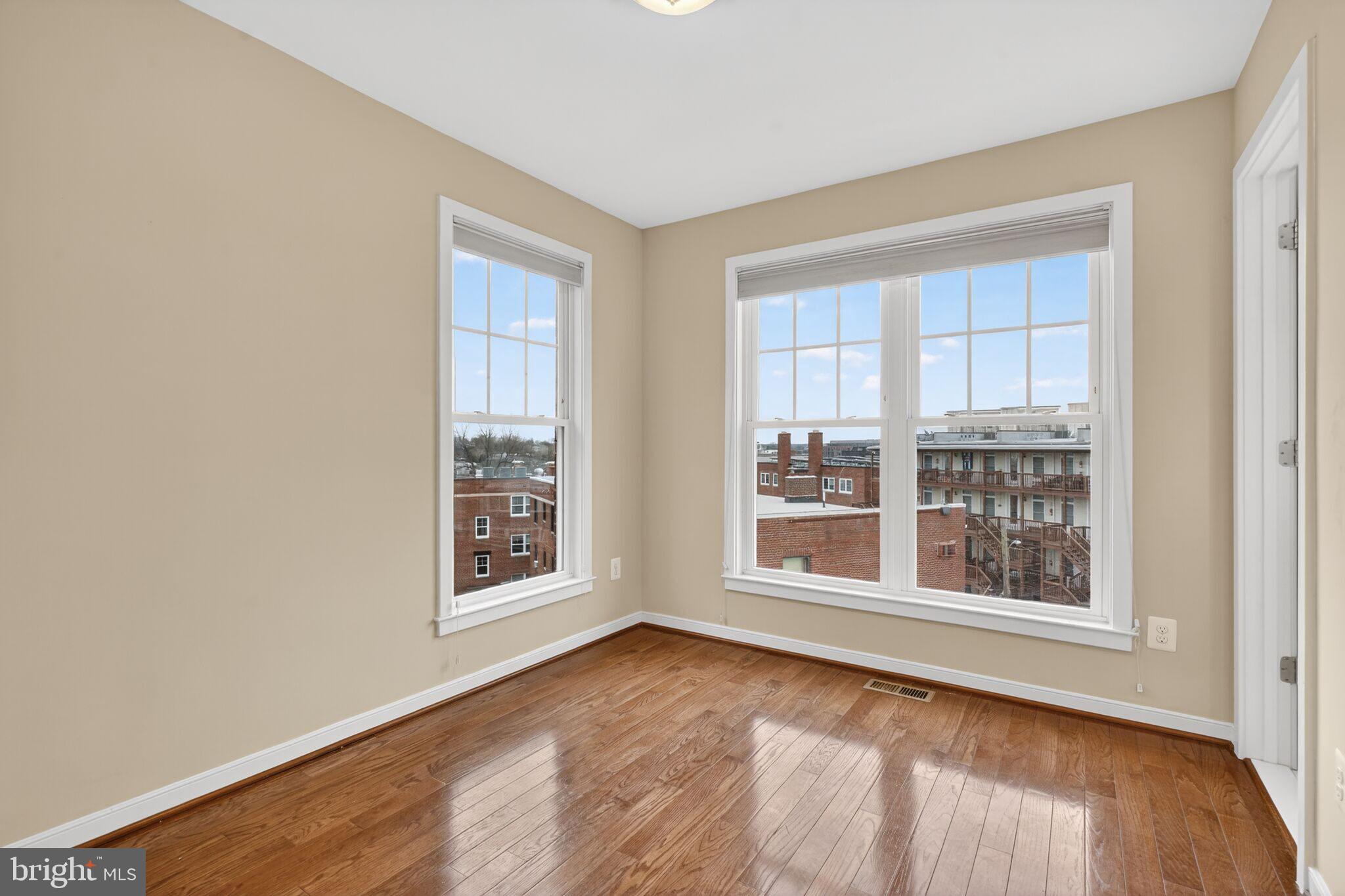 2909 Chancellor's Way Northeast Washington, DC 20017 - Photo 23 of 31 a view of an empty room with a window and wooden floor