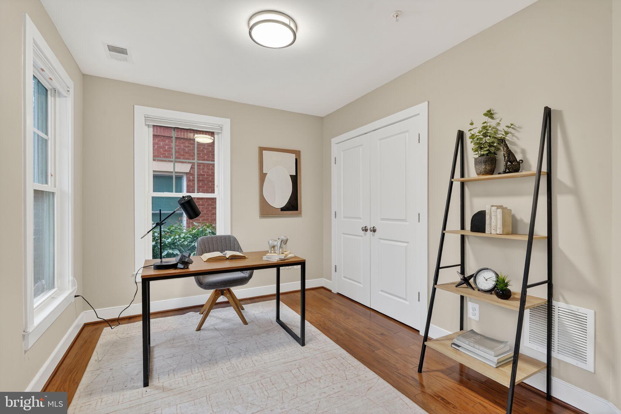 2909 Chancellor's Way Northeast Washington, DC 20017 - Photo 4 of 31 a view of a workspace room with wooden floor and windows