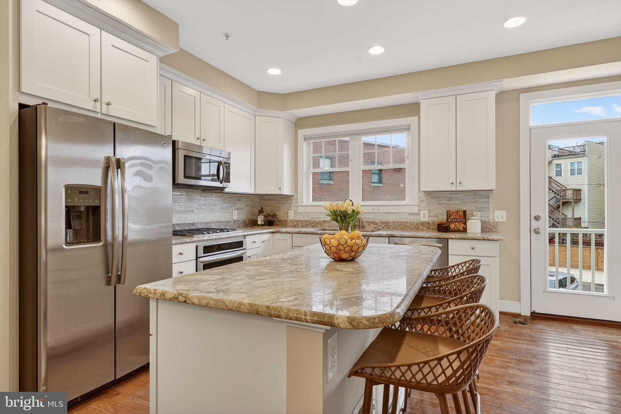 2909 Chancellor's Way Northeast Washington, DC 20017 - Photo 5 of 31 a kitchen with stainless steel appliances granite countertop a refrigerator a sink and a stove