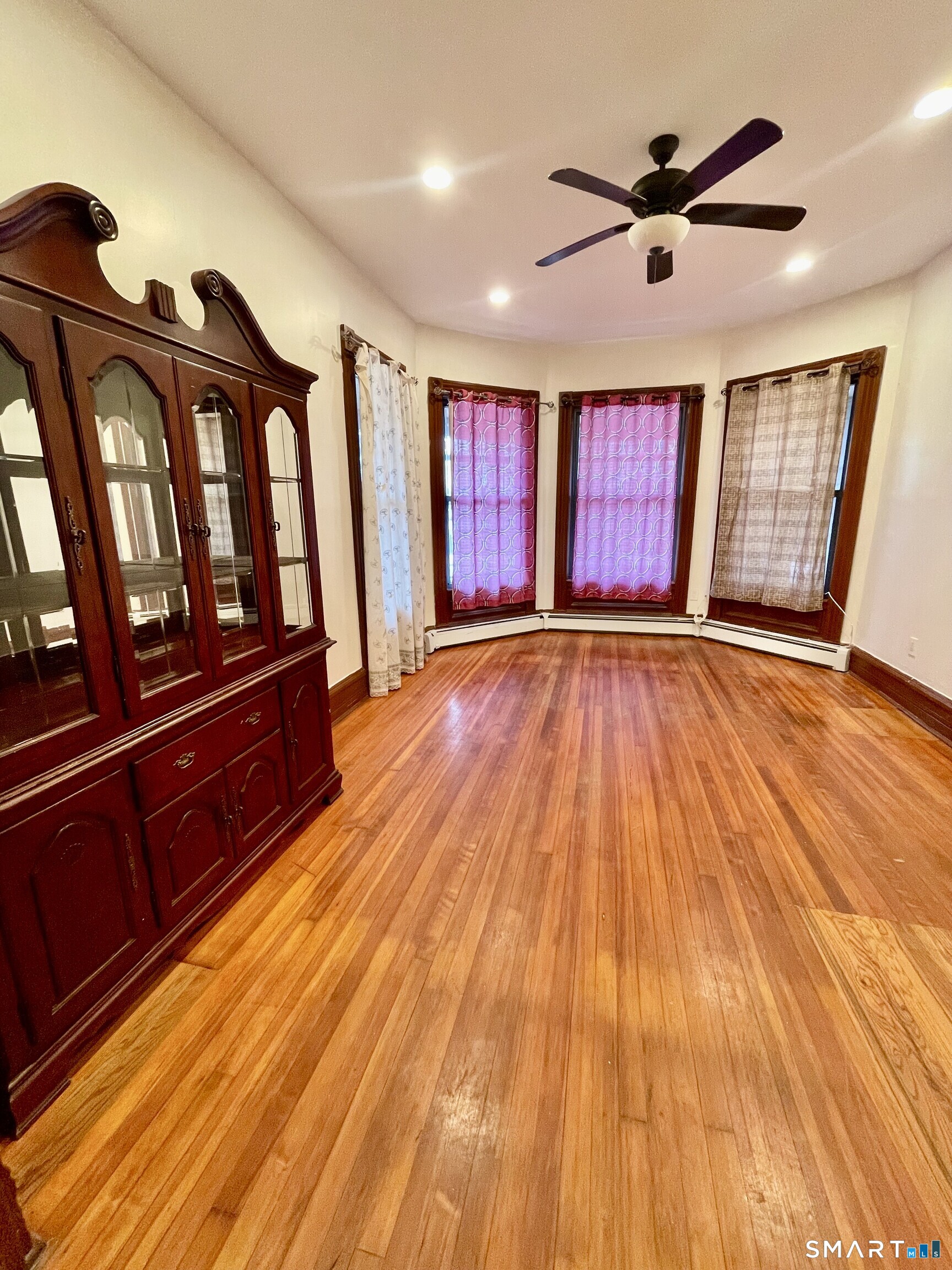 Undisclosed Address Bridgeport, CT 06608 - Photo 6 of 10 a view of an empty room with wooden floor and a window