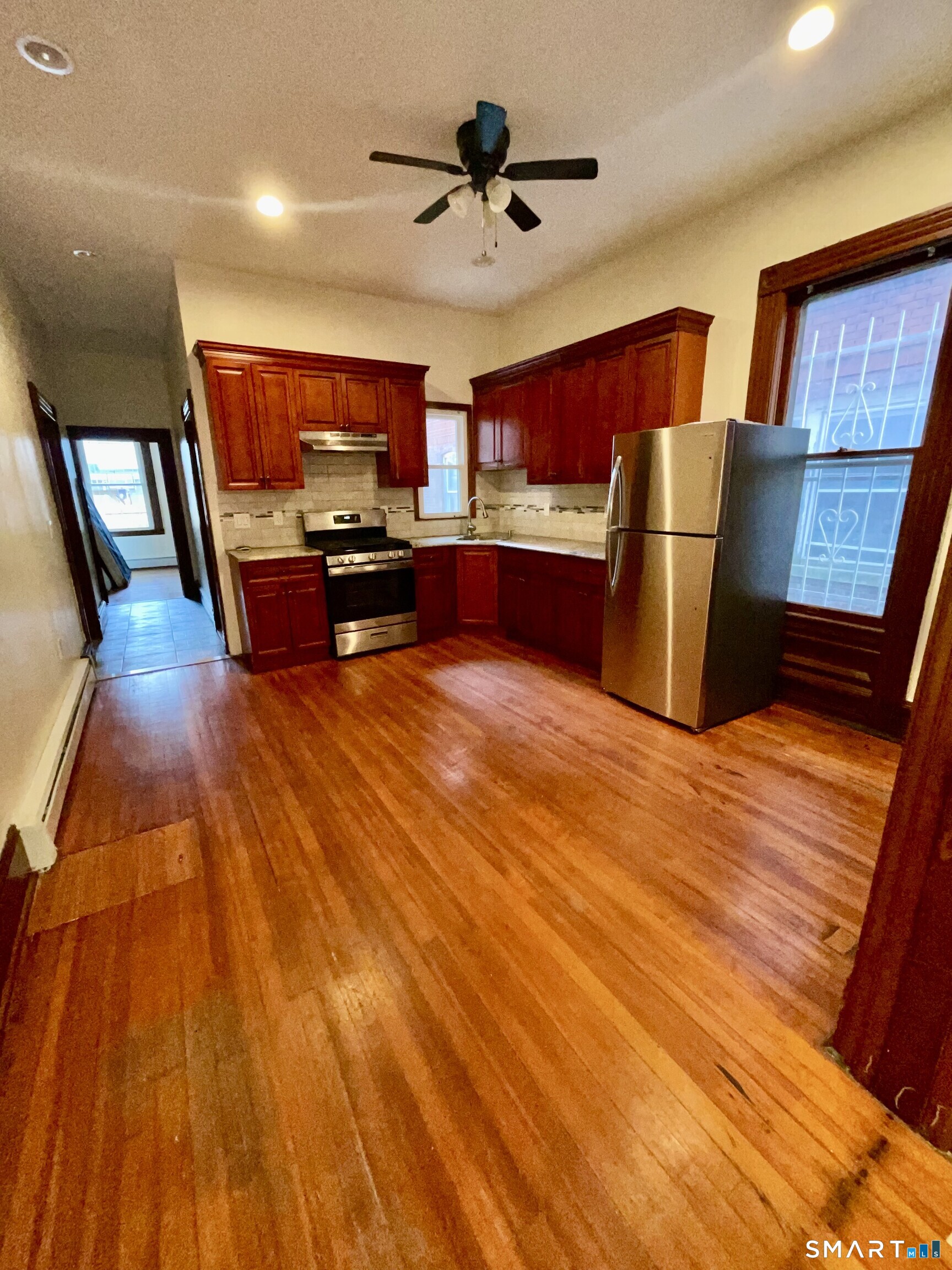 Undisclosed Address Bridgeport, CT 06608 - Photo 7 of 10 a living room with stainless steel appliances kitchen island granite countertop a stove and a wooden floors