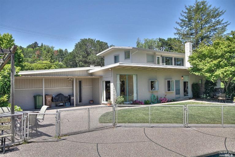 138 Circle Road San Rafael, CA 94903 - Photo 1 of 1 a view of a white house with a fountain in front of a yard
