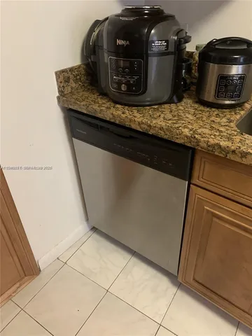 a view of a dining room with furniture and a kitchen view