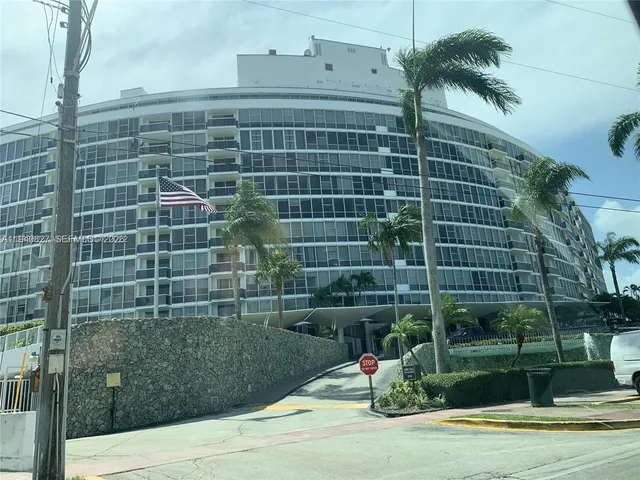 a view of living room filled with furniture and floor to ceiling window