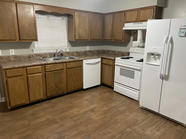 a kitchen with white cabinets sink and white appliances