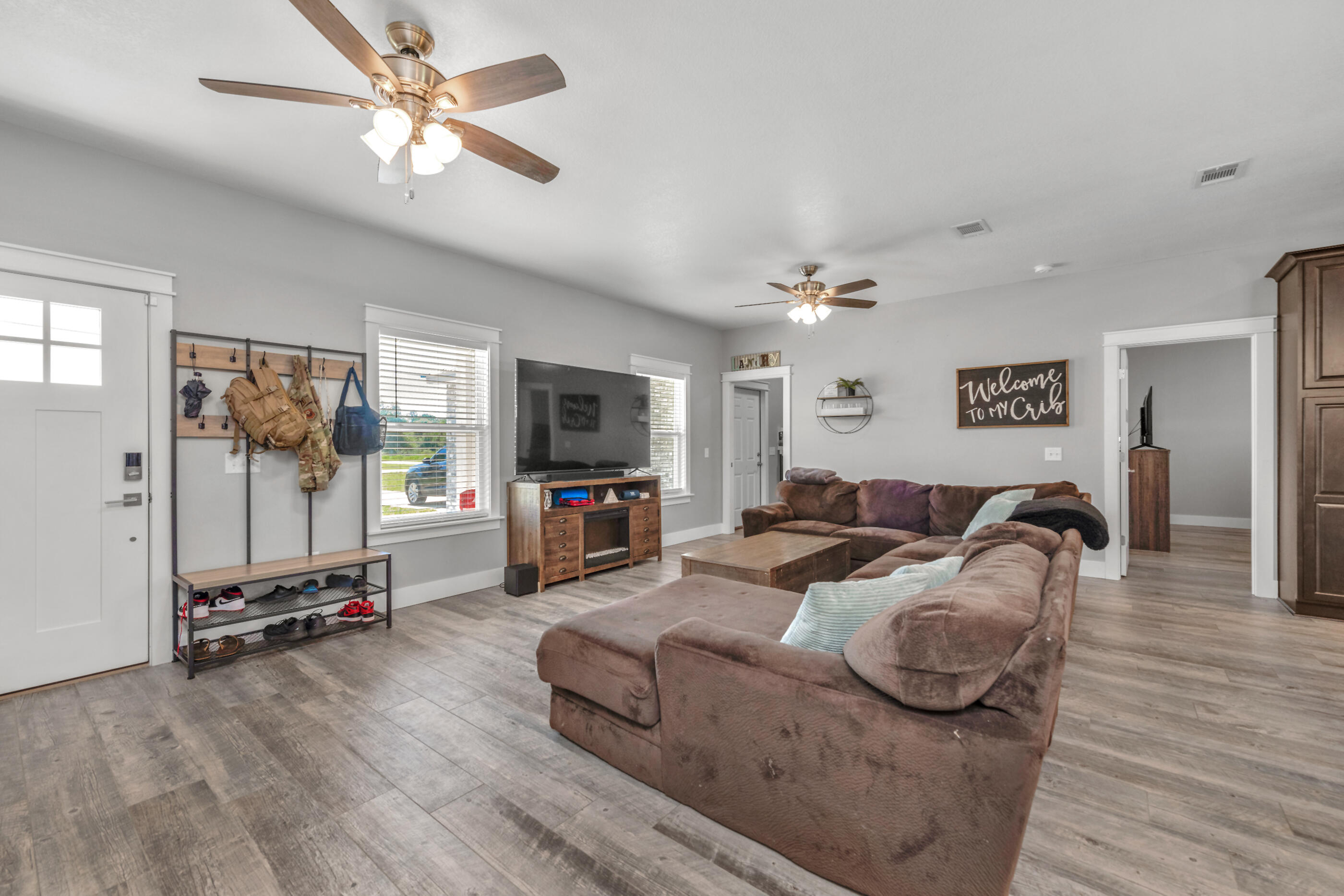 6116 Robin Road Crestview, FL 32539 - Photo 13 of 24 a living room with furniture gym equipment and a flat screen tv