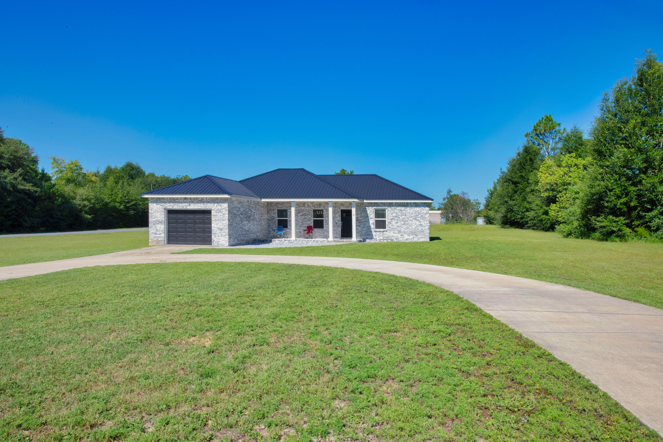 6116 Robin Road Crestview, FL 32539 - Photo 3 of 24 a front view of a house with a garden