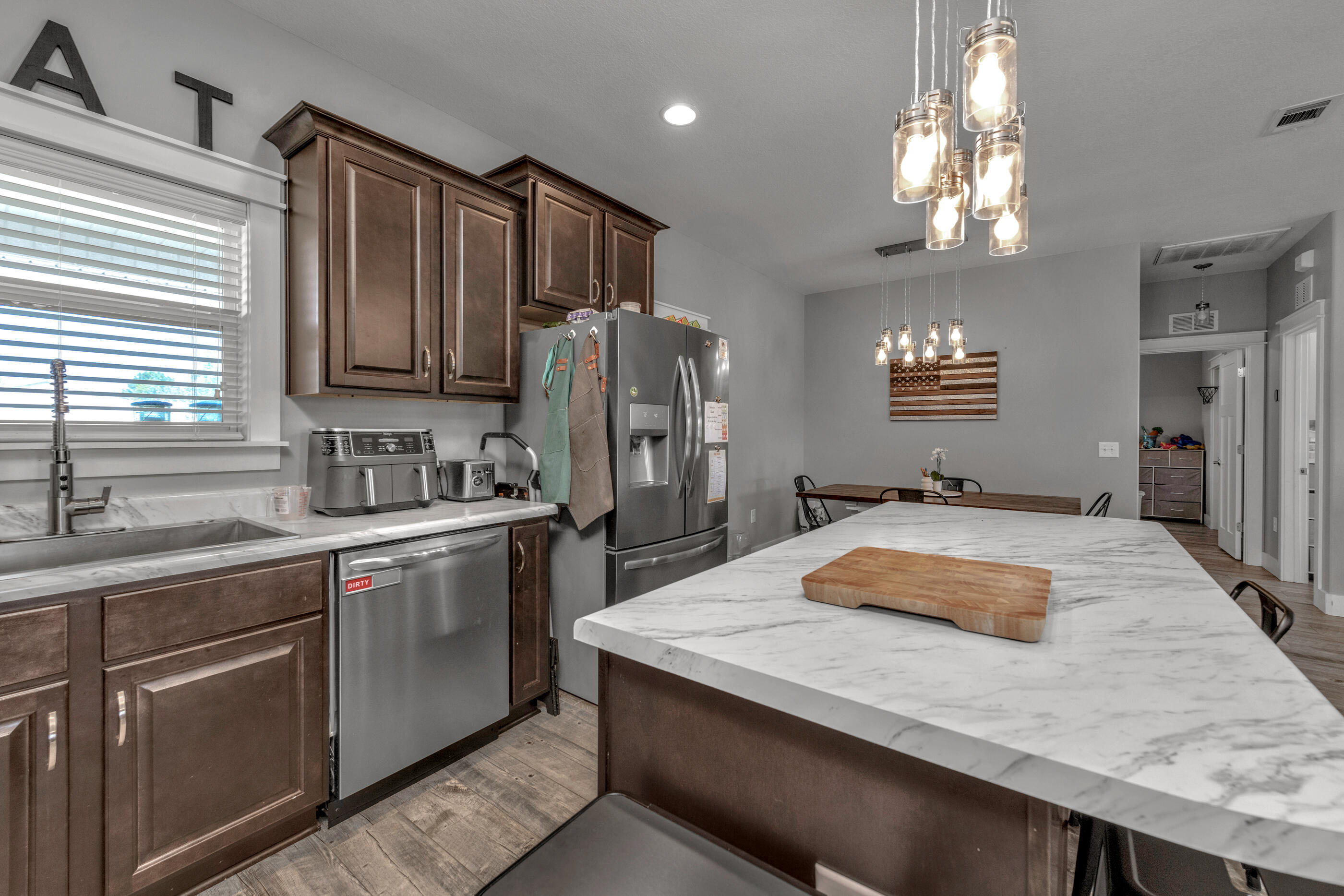6116 Robin Road Crestview, FL 32539 - Photo 6 of 24 a kitchen with stainless steel appliances granite countertop a sink refrigerator and cabinets