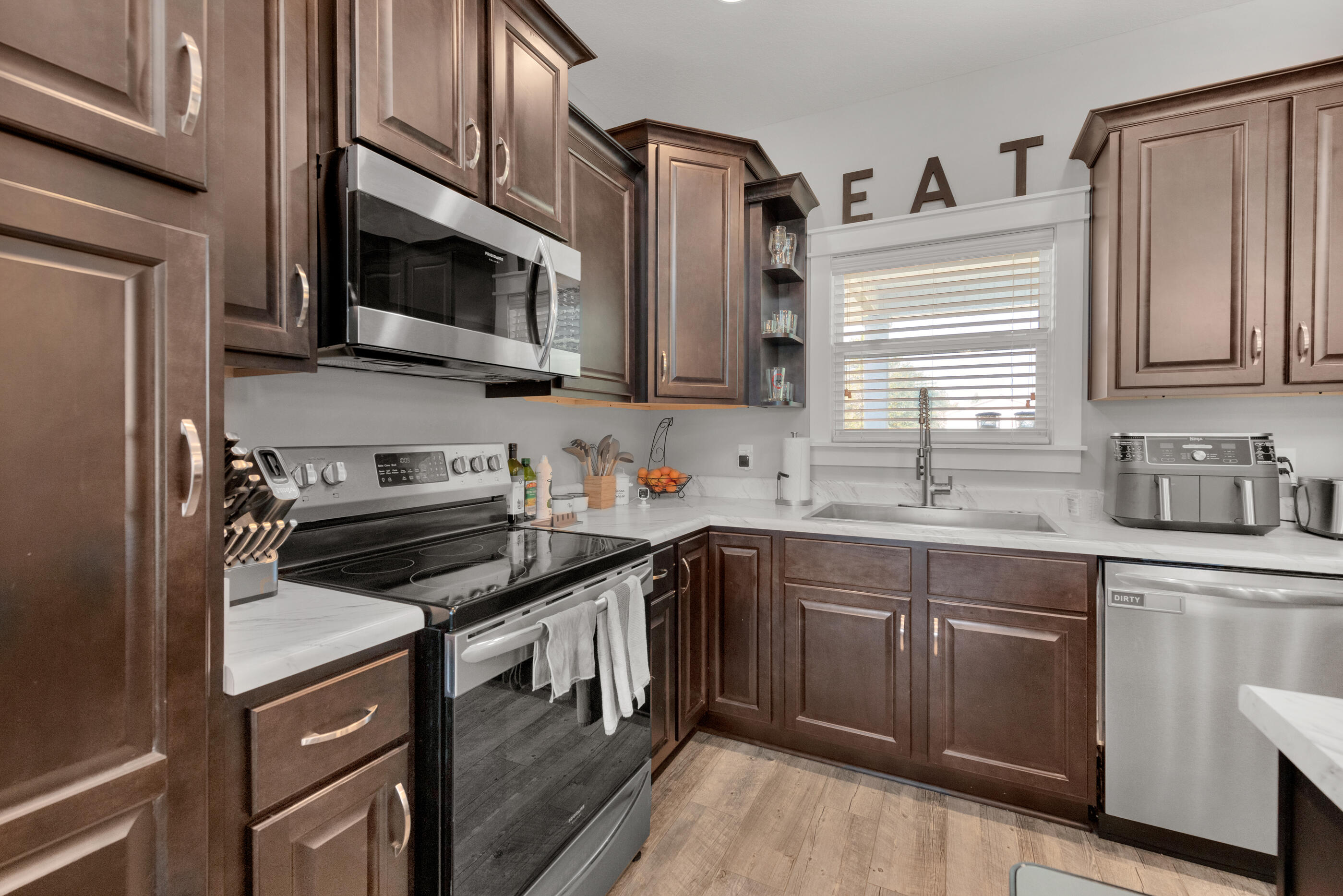 6116 Robin Road Crestview, FL 32539 - Photo 7 of 24 a kitchen with stainless steel appliances a sink dishwasher stove and oven