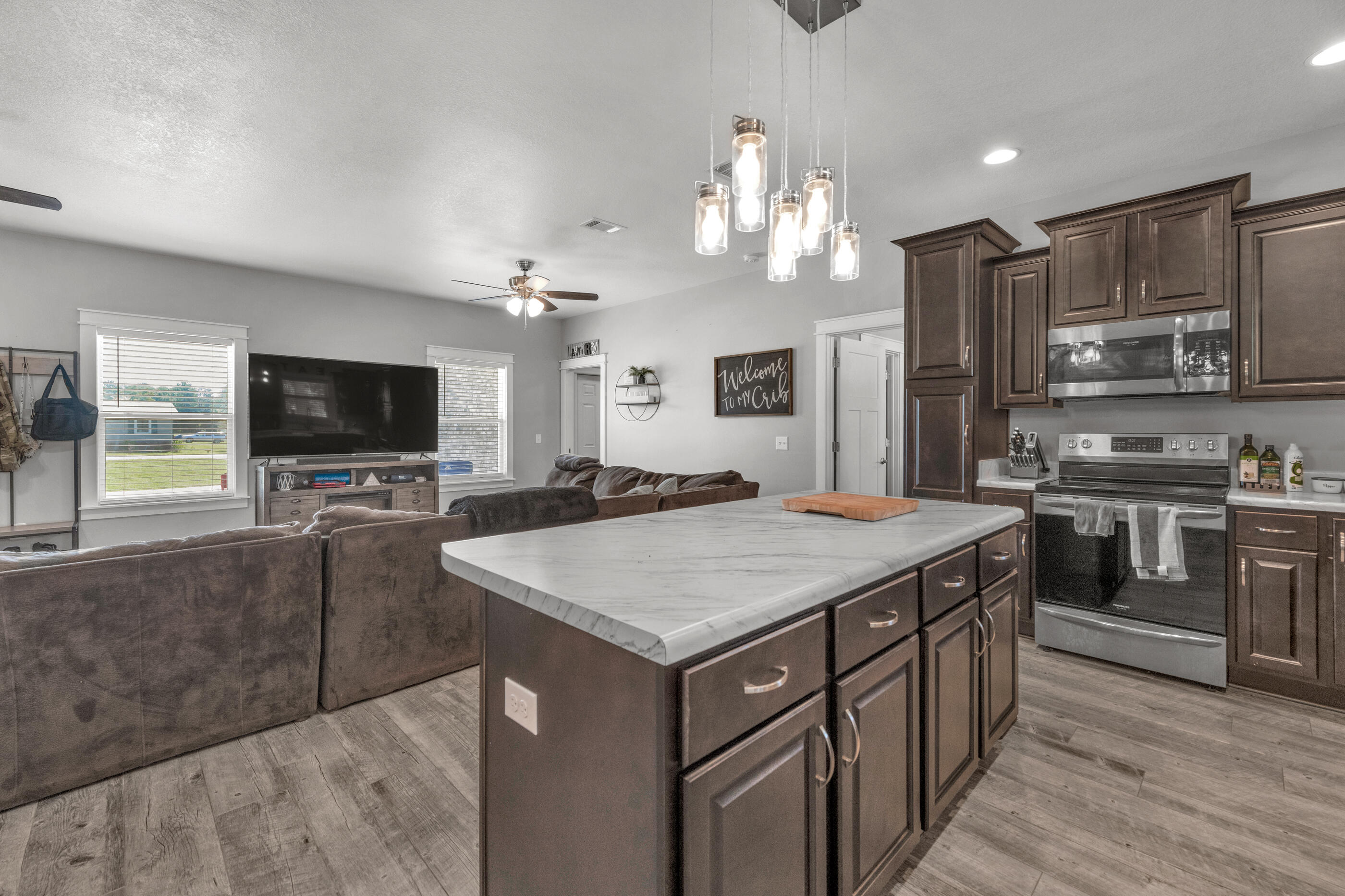 6116 Robin Road Crestview, FL 32539 - Photo 9 of 24 a kitchen with stainless steel appliances granite countertop a sink stove and refrigerator