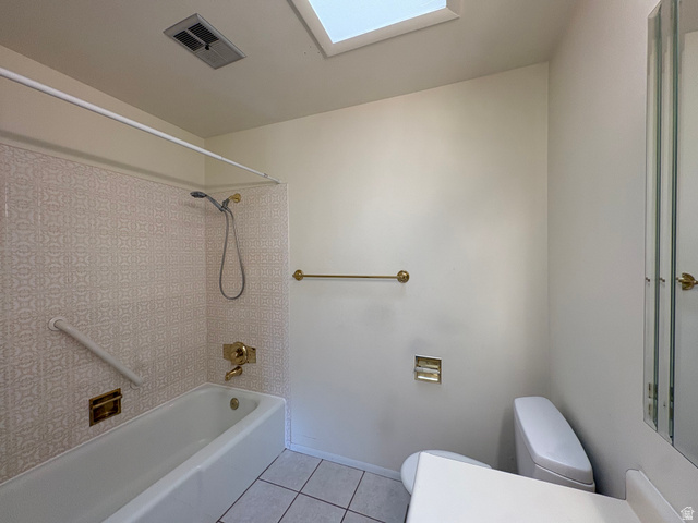 595 Meadowlark Road Orem, UT 84097 - Photo 41 of 87 Full bathroom with a tub/shower combination, patterned wall tile, skylight, and white floor tile