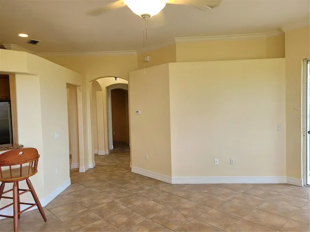 a view of a hallway with wooden floor and a cabinet