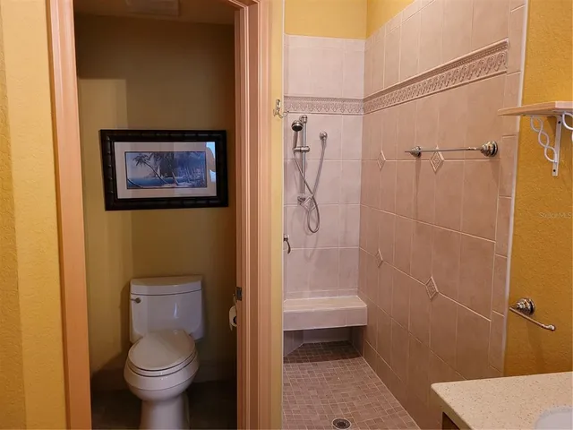 a bathroom with a toilet and a shower