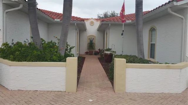 a view of a house with potted plants