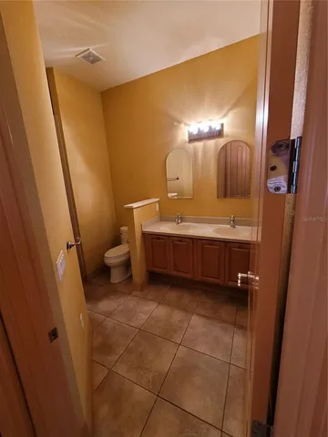 a bathroom with a sink a toilet and a mirror