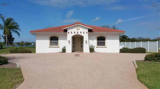 a view of a house with a yard and plants